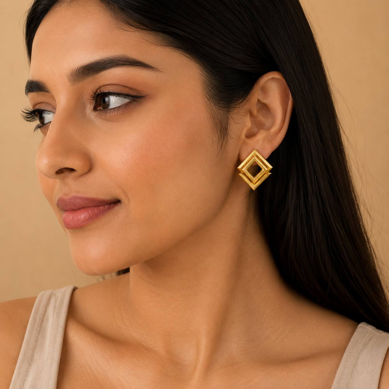 Woman wearing golden geometric statement earrings