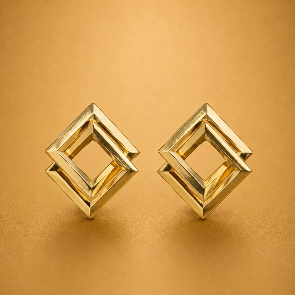 Golden geometric statement earrings with interlocking square design