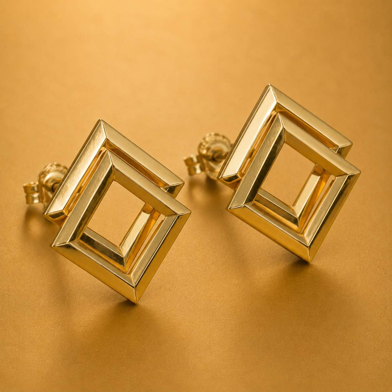 Close-up of gold geometric earrings with polished finish