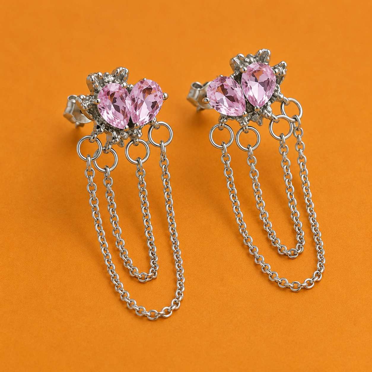 Close-up of pink crystal drop earrings with cascading chains