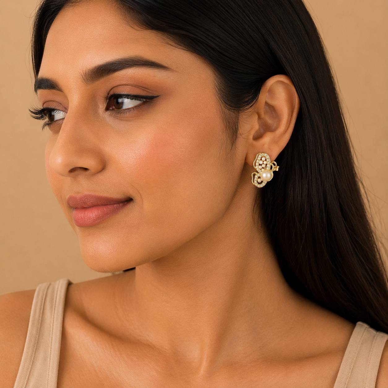 Woman wearing pearl butterfly statement earrings