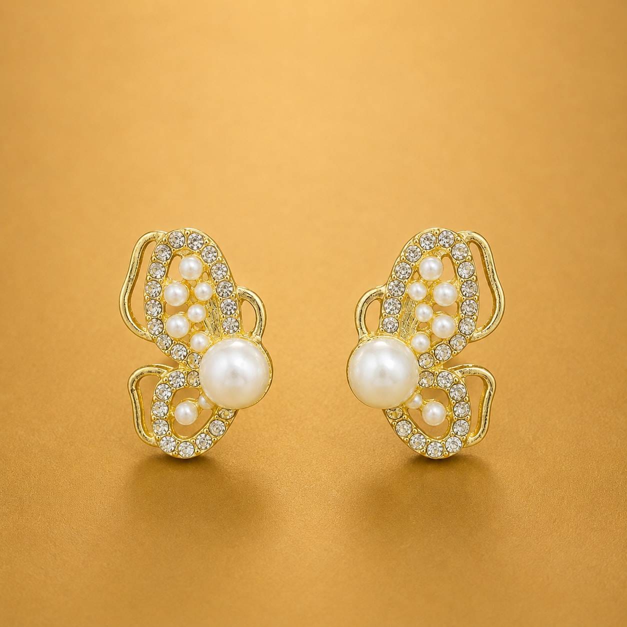 Pearl butterfly earrings with clear stones and gold-tone detailing