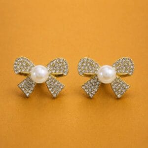 Étoile pearl bow earrings with clear stones and gold-tone detailing